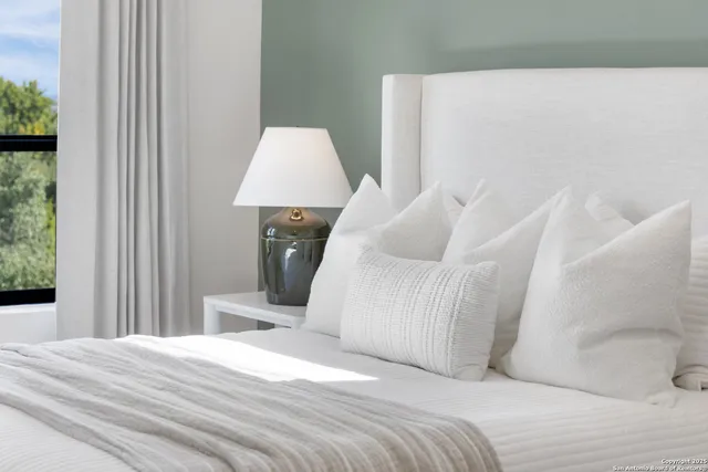 a bedroom with a bed and a chair