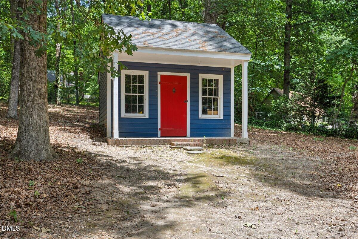 6516 Bakersfield Drive Raleigh, NC 27606 - Photo 47 of 59 a view of a house with a yard and large tree