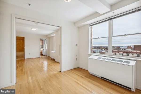 a view of a kitchen with wooden floor and a window