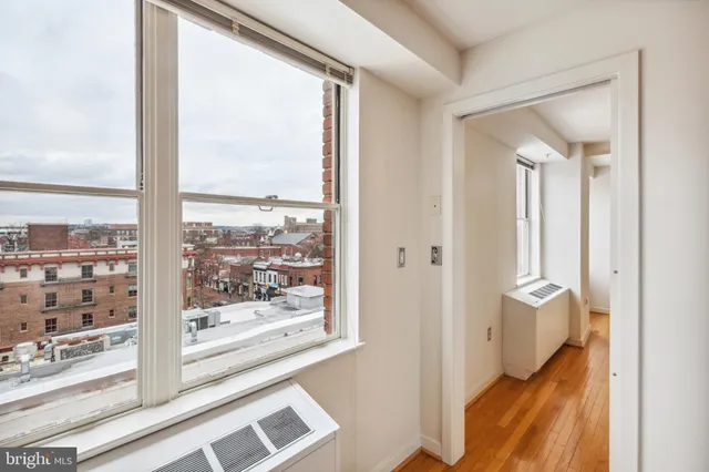a view of a closet and a living room