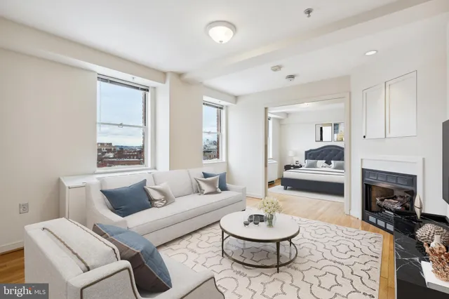 a living room with furniture a fireplace and a table