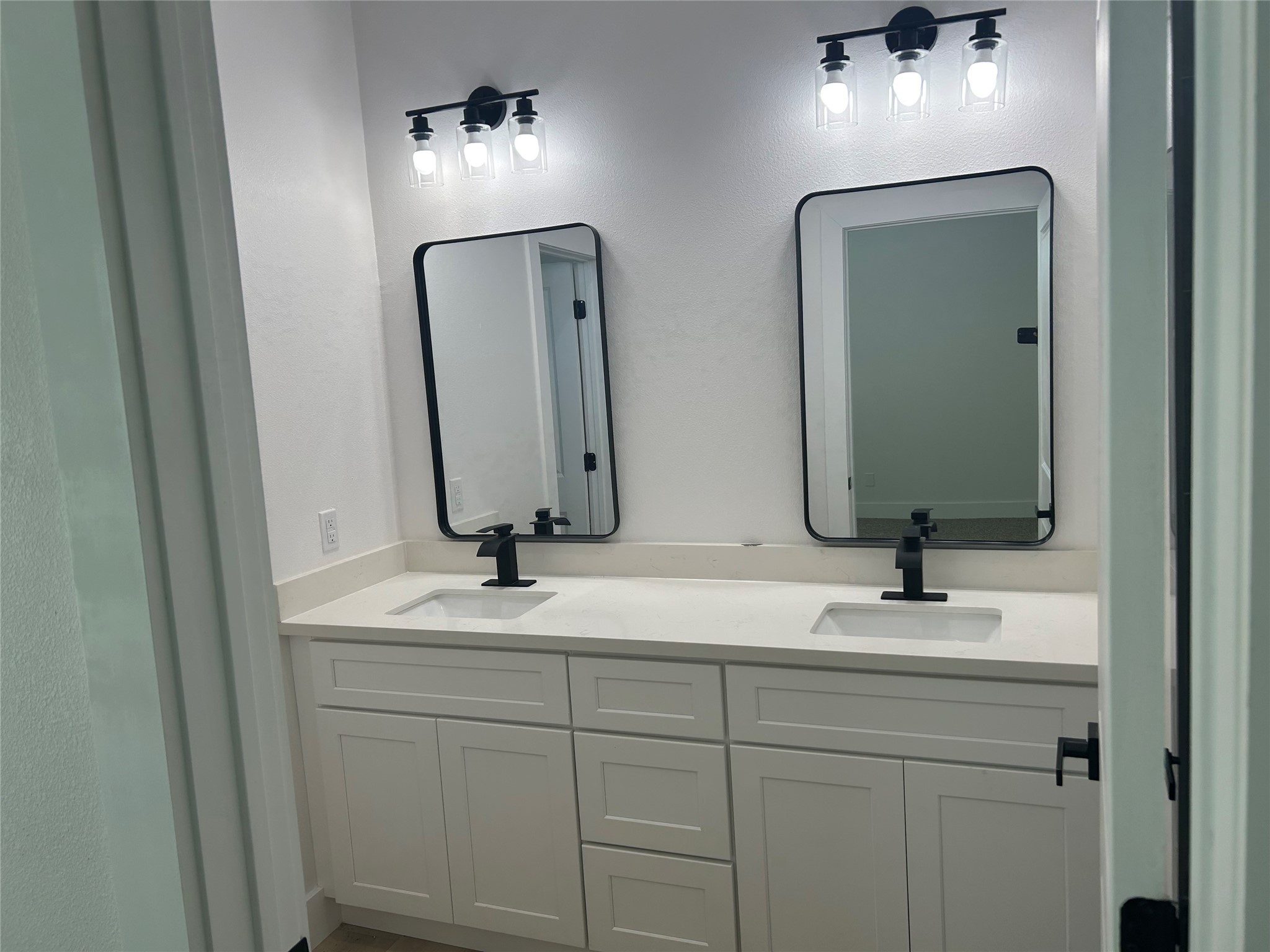 8203 Sparta Street, Unit B Houston, TX 77028 - Photo 11 of 12 a bathroom with double vanity sinks and a mirror