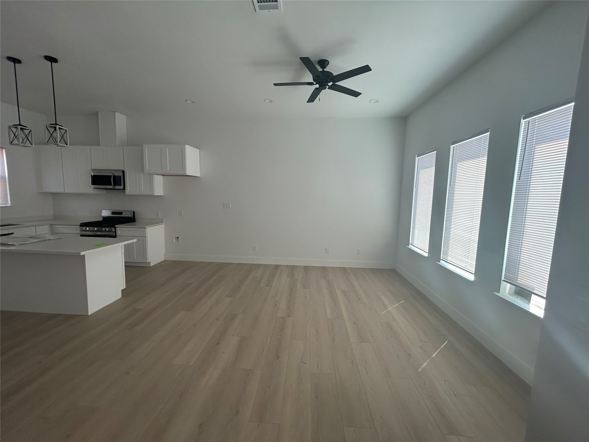 8203 Sparta Street, Unit B Houston, TX 77028 - Photo 3 of 12 a view of a kitchen with a sink dishwasher and wooden floor