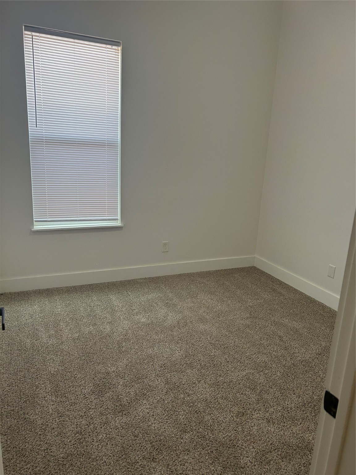 8203 Sparta Street, Unit B Houston, TX 77028 - Photo 6 of 12 an empty room with a window