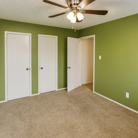 a view of an empty room with a fan