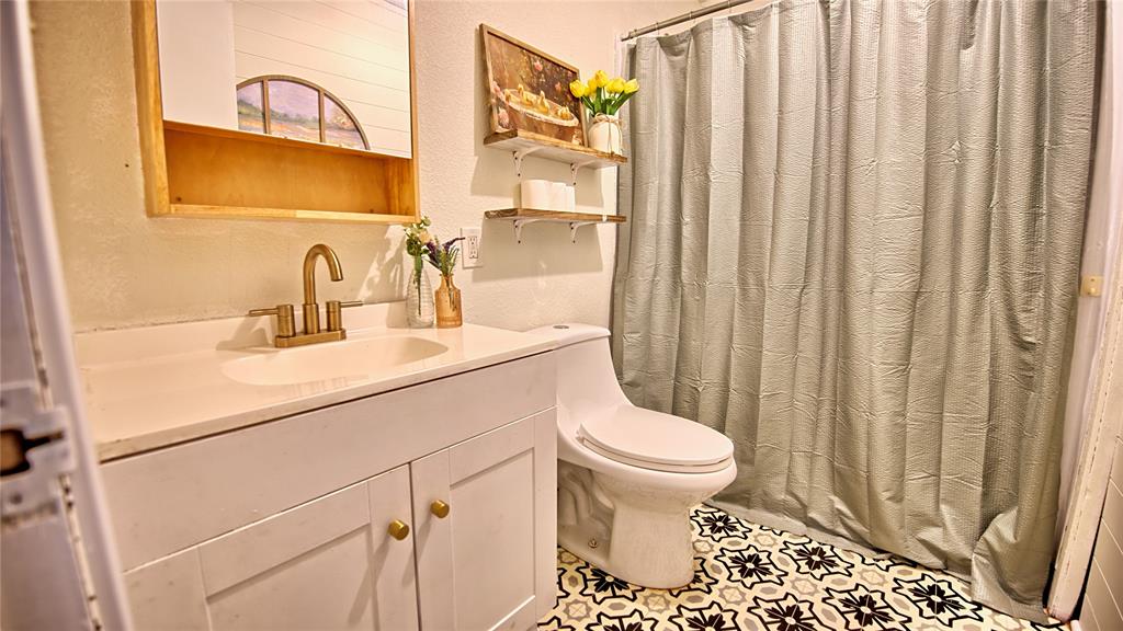 140 Elm Road Nocona, TX 76255 - Photo 16 of 26 a bathroom with a sink toilet and shower