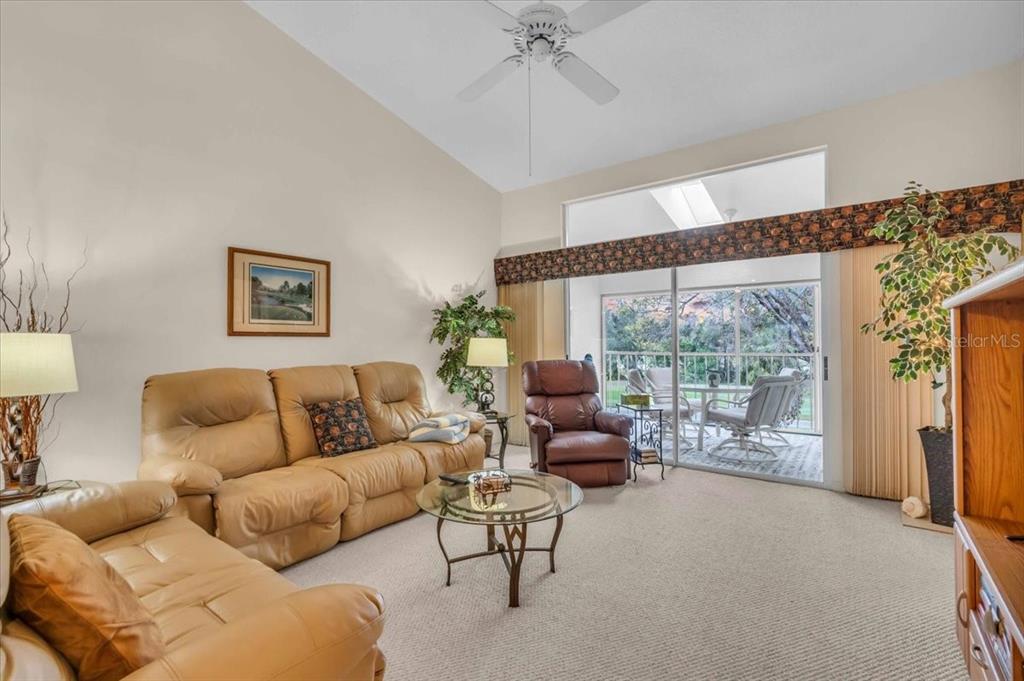 6713 Stone River Road, Unit 206 Bradenton, FL 34203 - Photo 10 of 58 a living room with furniture and a large window