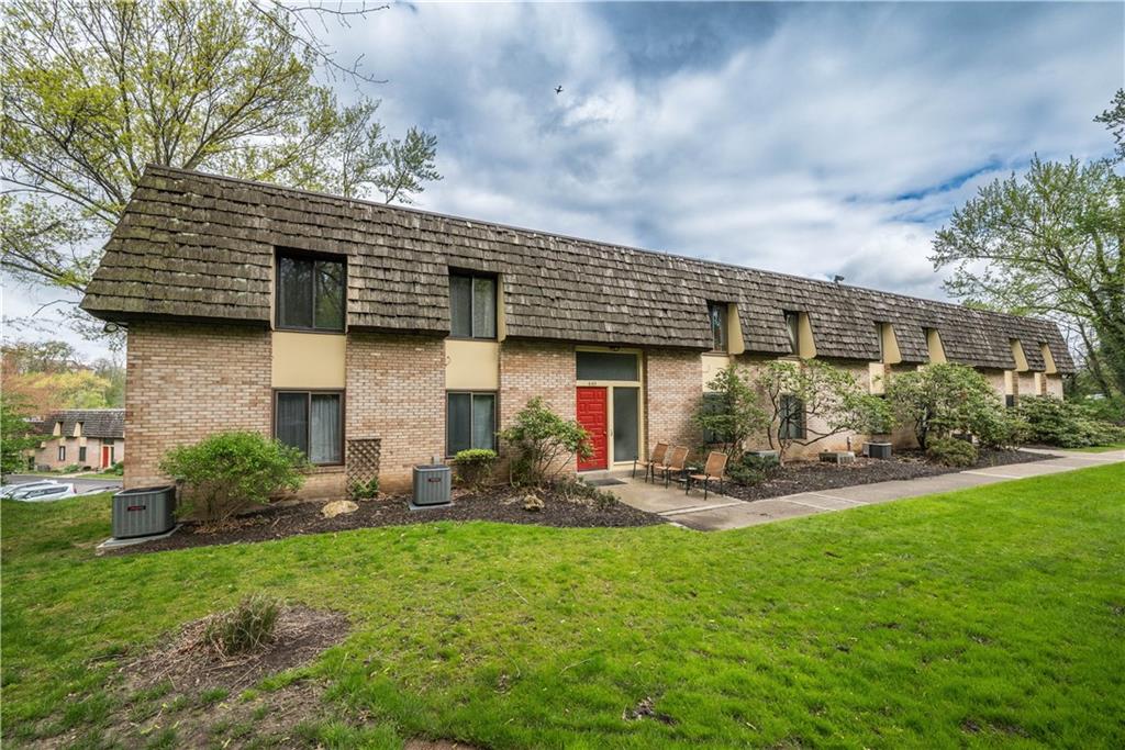 a front view of a house with a yard and sitting area