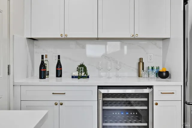a kitchen with white cabinets and a sink