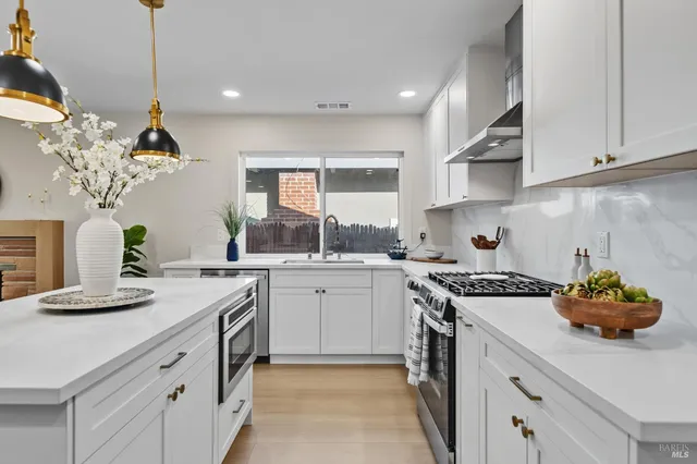a kitchen with a white cabinets and white appliances