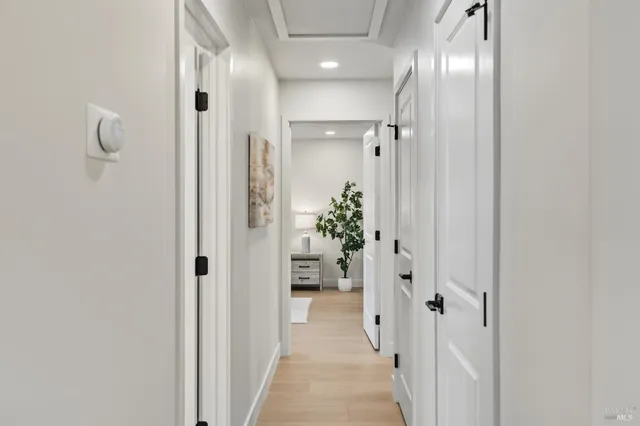 a view of a hallway with wooden shelves