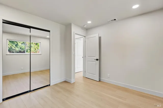 an empty room with sliding glass door and shower