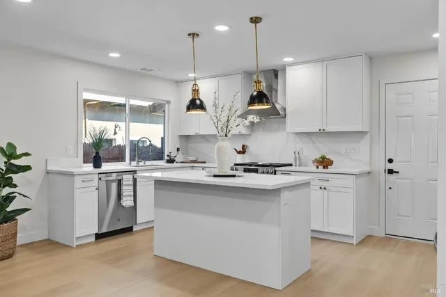 a kitchen with white cabinets and white appliances