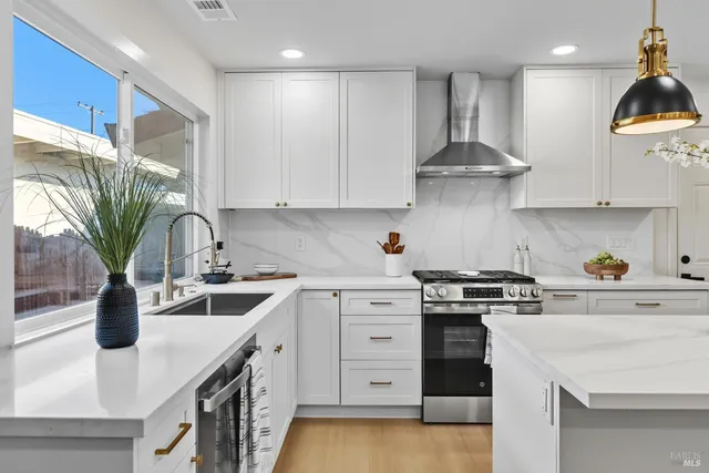 a kitchen with a sink a stove and cabinets