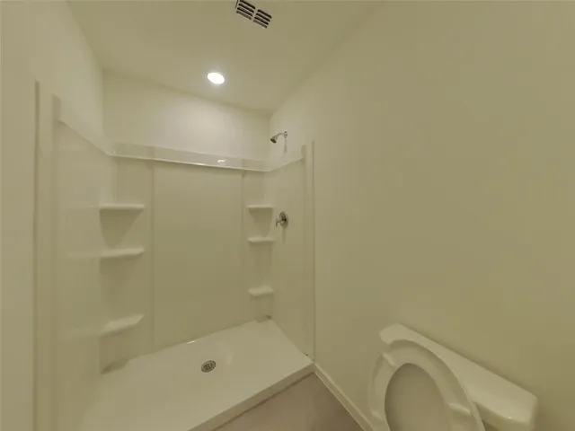 a bathroom with a shower and toilet