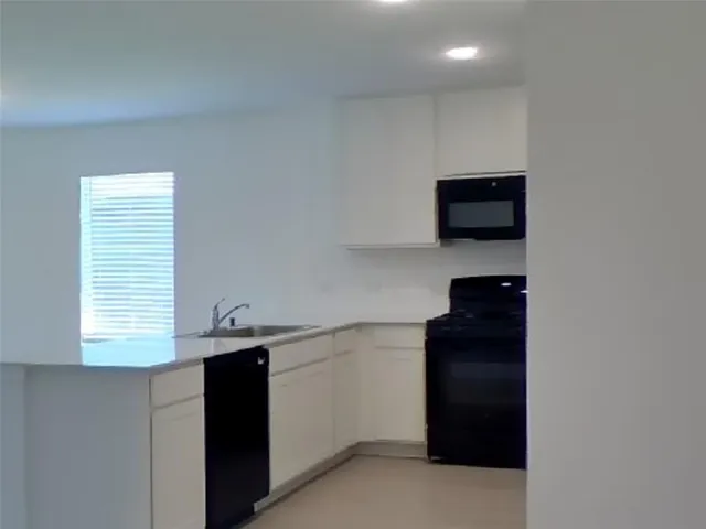 a kitchen with a sink and a window