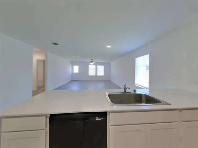 a kitchen with a sink and cabinet