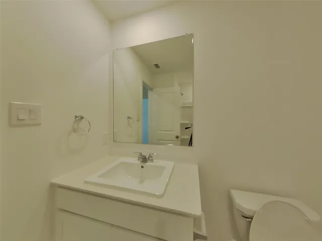 a bathroom with a sink toilet and mirror