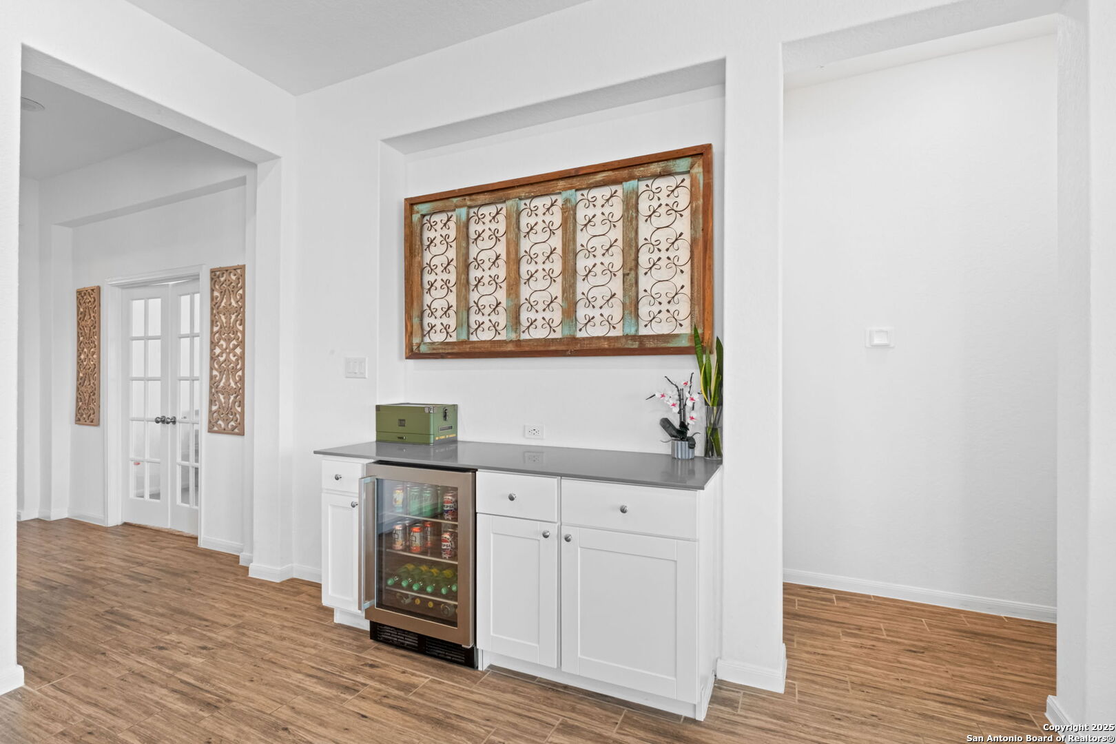 8950 Rancher Place Seguin, TX 78155 - Photo 13 of 34 an empty room with wooden floor cabinet and windows