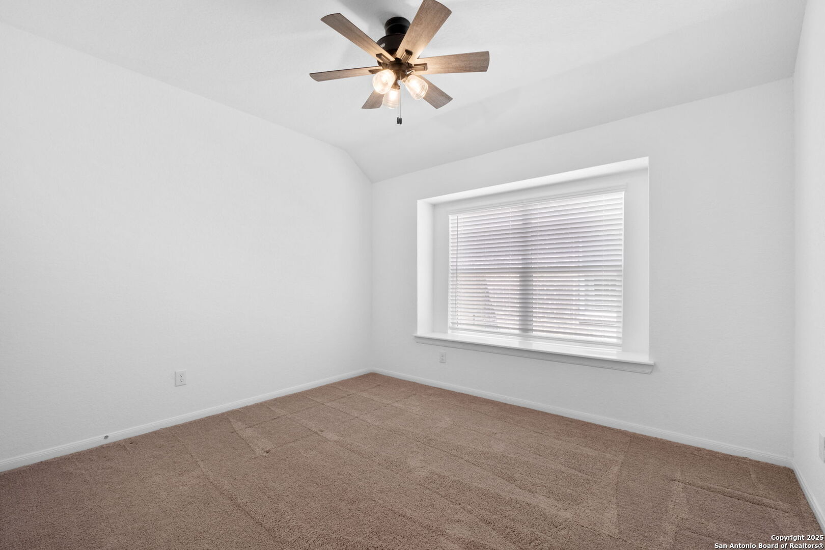 8950 Rancher Place Seguin, TX 78155 - Photo 25 of 34 an empty room with a window and a fan