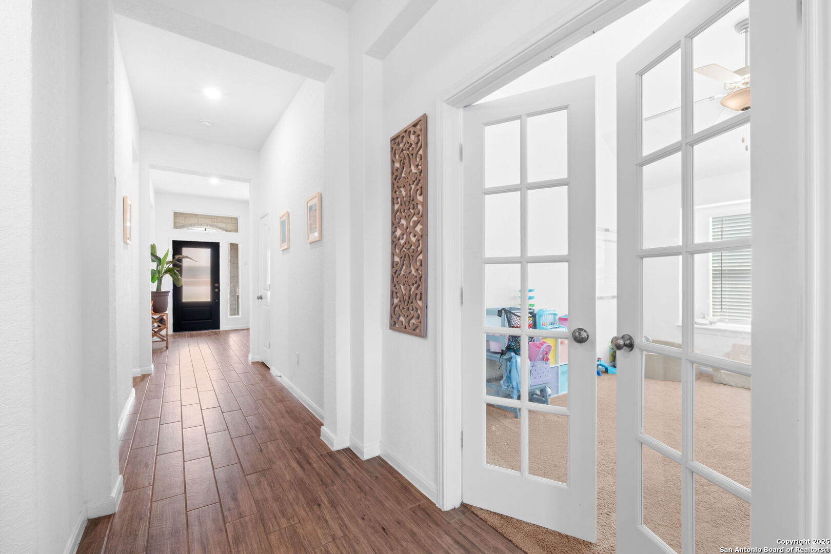 8950 Rancher Place Seguin, TX 78155 - Photo 26 of 34 a view of hallway with wooden floor and windows