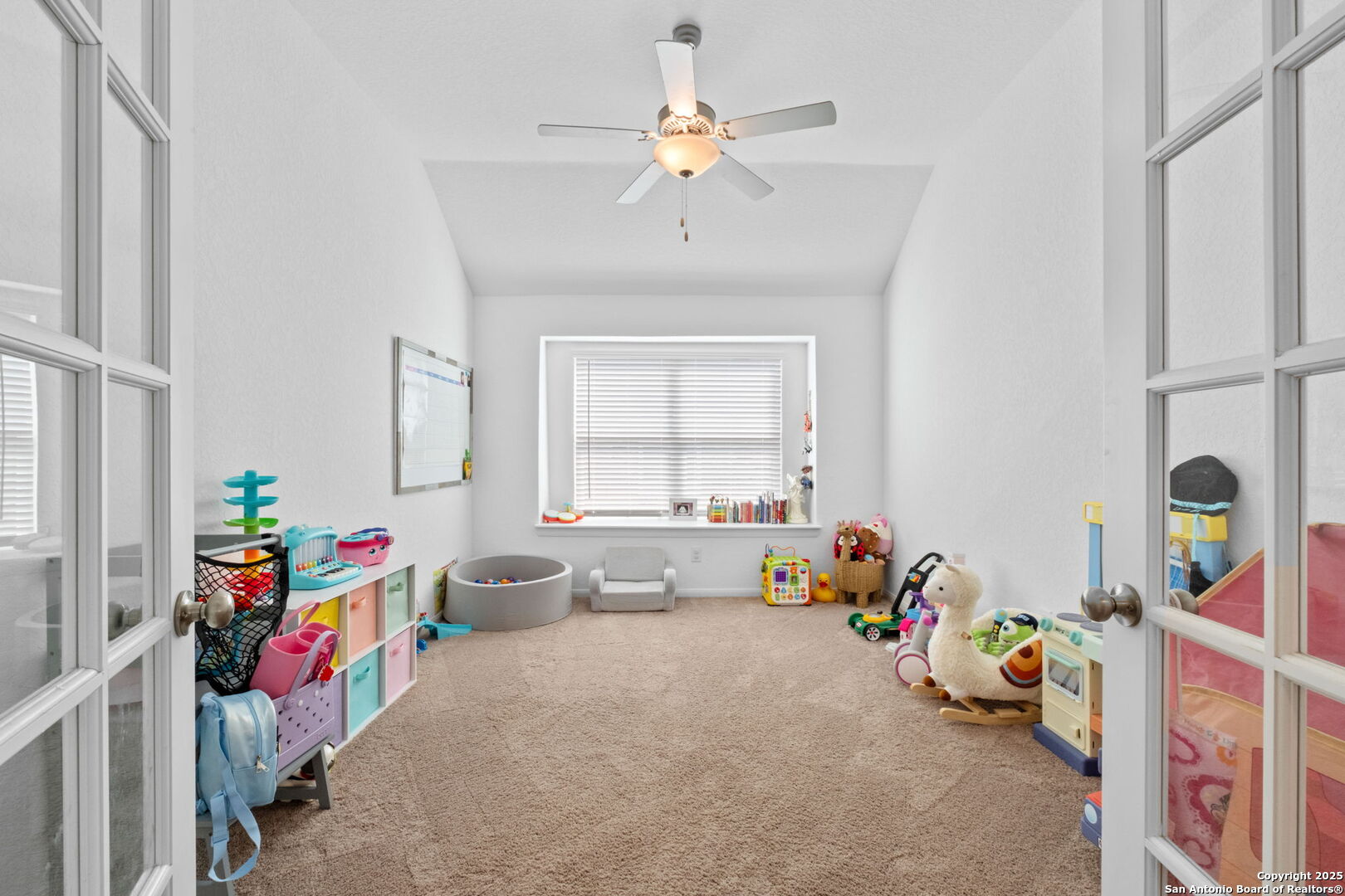 8950 Rancher Place Seguin, TX 78155 - Photo 27 of 34 a children room with toys and a chandelier
