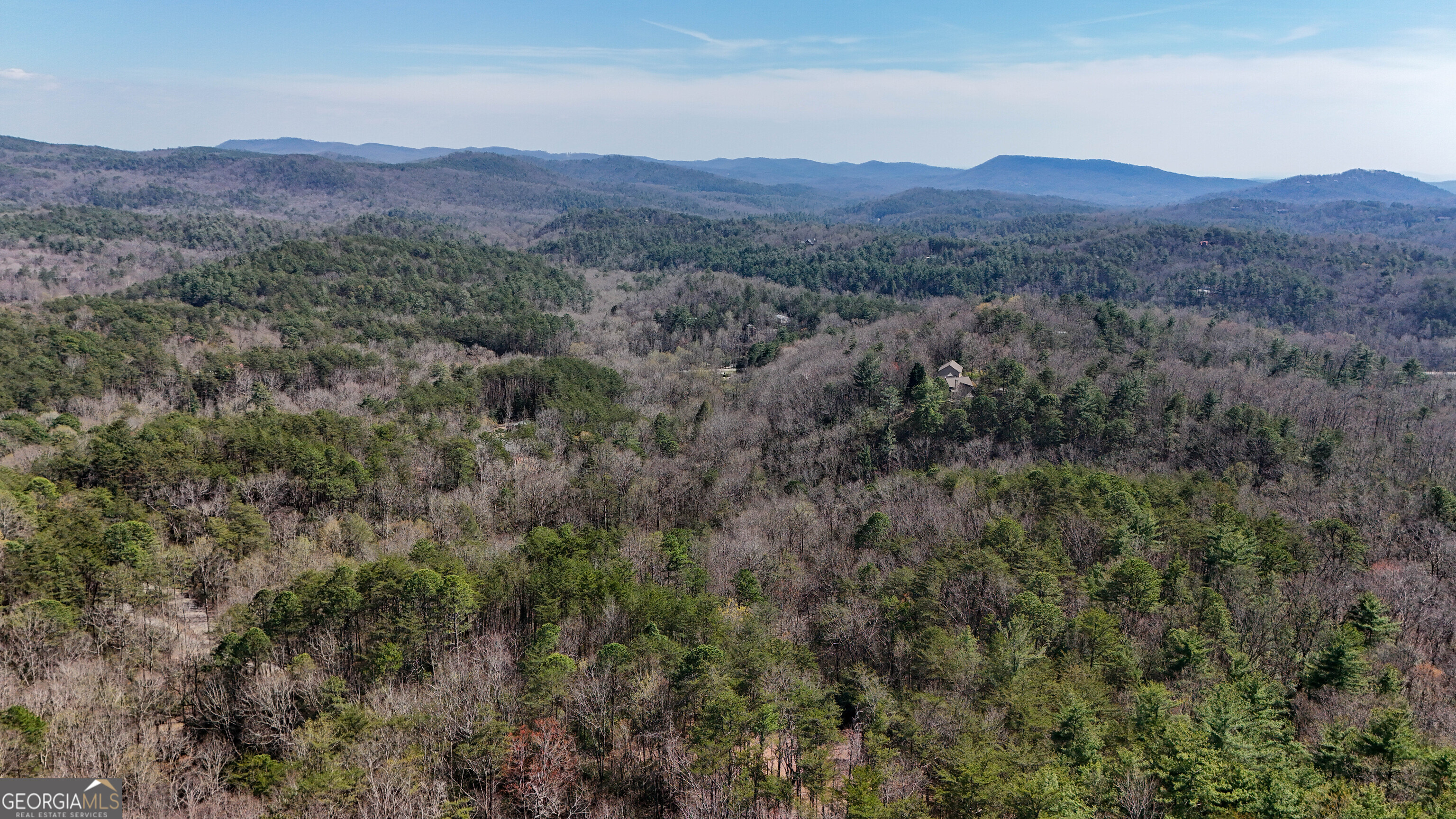 6 Chimney Mountain Road Sautee Nacoochee, GA 30571 - Photo 6 of 72 a view of a lush green hillside and a houses