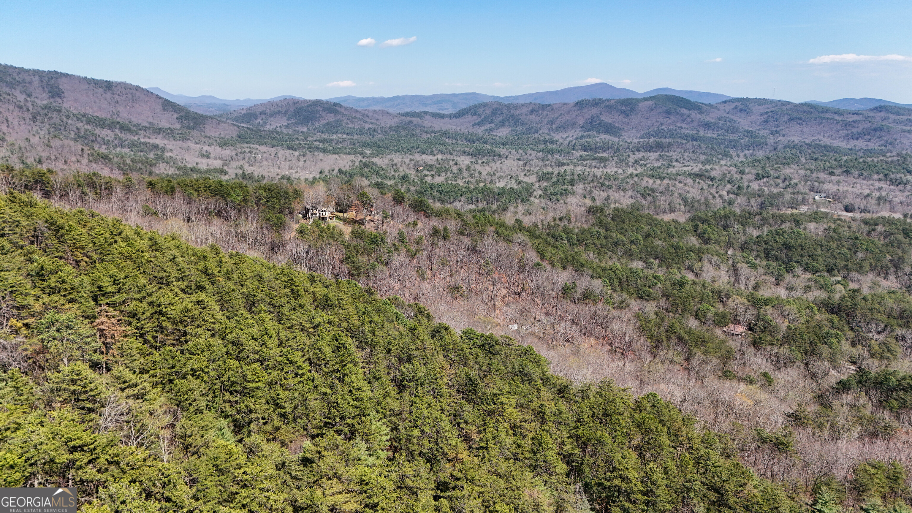 6 Chimney Mountain Road Sautee Nacoochee, GA 30571 - Photo 8 of 72 a view of a lush green hillside and a houses
