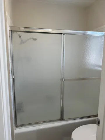 a bathroom with a shower and toilet