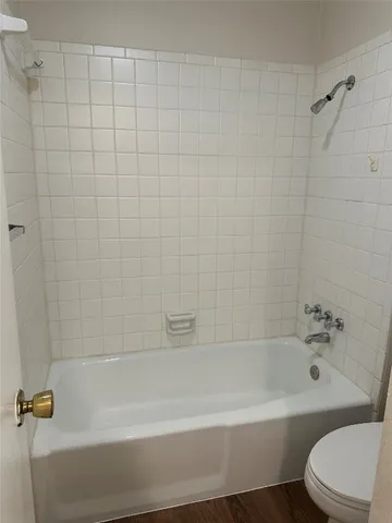 a bathroom with a bathtub and a toilet