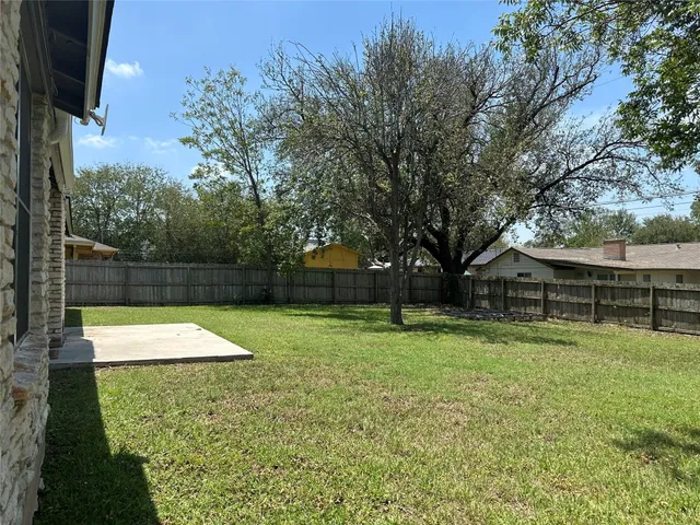 a backyard of a house with lots of green space