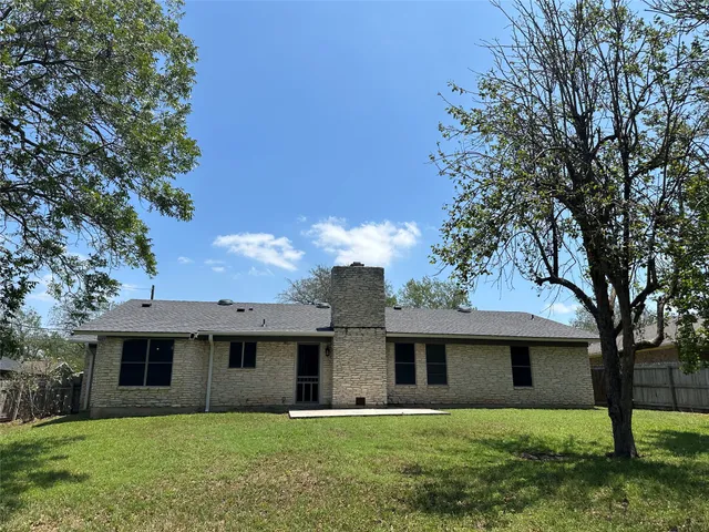 a front view of a house with yard and green space