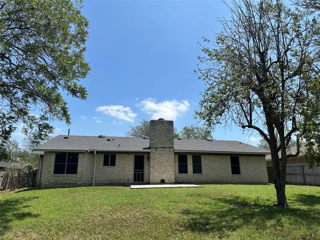 a front view of a house with yard and green space