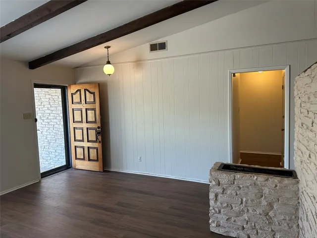 a view of an entryway with wooden floor