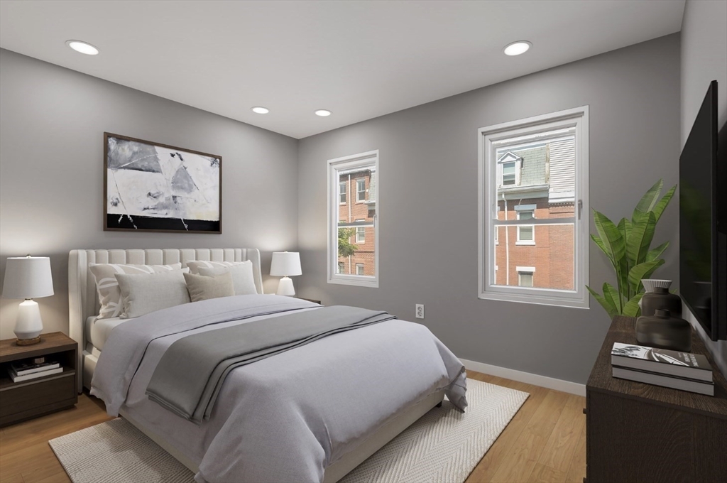 769 East 6th Street, Unit 1 Boston, MA 02127 - Photo 6 of 18 a bedroom with a bed and a flat screen tv