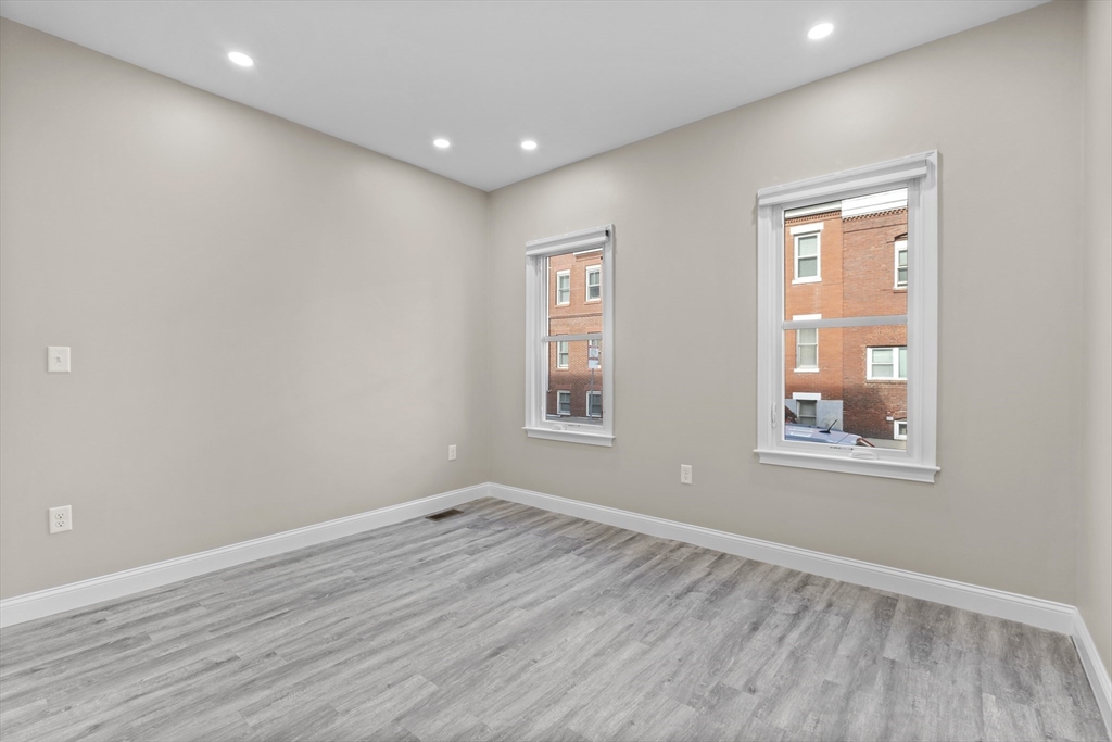 769 East 6th Street, Unit 1 Boston, MA 02127 - Photo 7 of 18 a view of empty room with wooden floor and fan