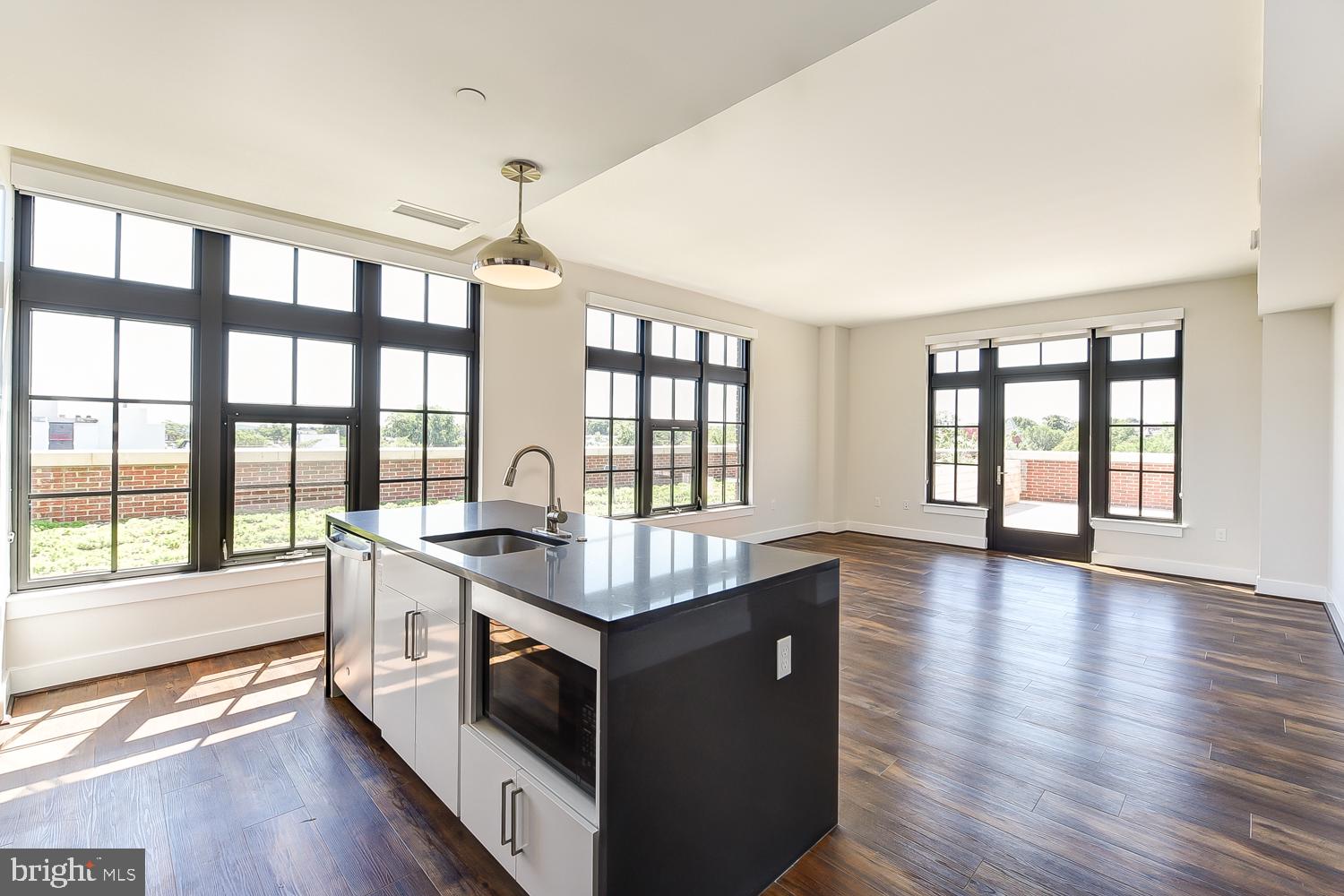 901 H Street Northeast, Unit 643 Washington, DC 20002 - Photo 4 of 82 a kitchen with a stove and wooden cabinets