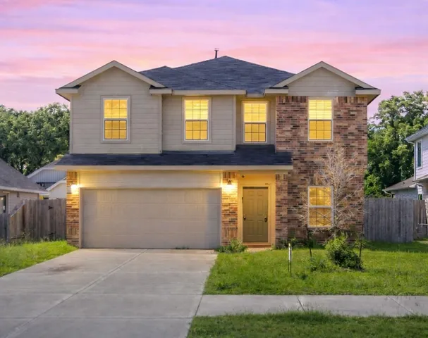 a front view of a house with a yard and garage