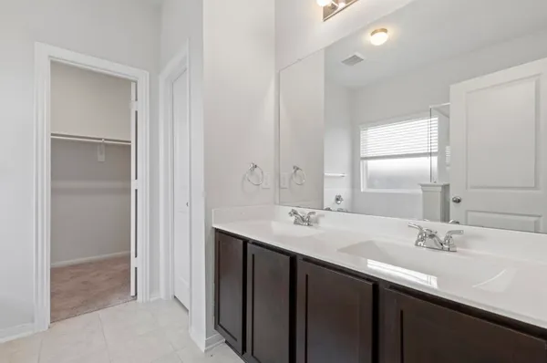 a bathroom with a sink double vanity and a mirror