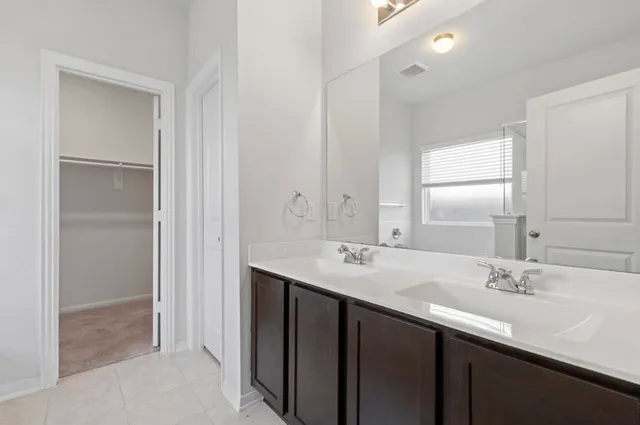 a bathroom with a sink double vanity and a mirror