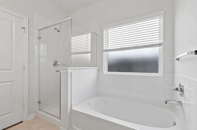 a white bath tub sitting next to a window