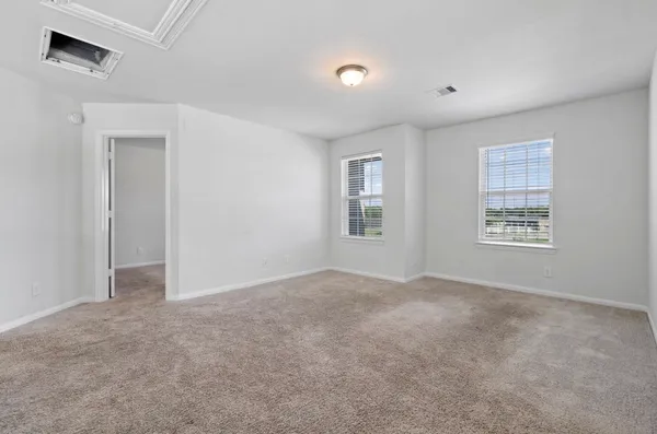 an empty room with windows and closet
