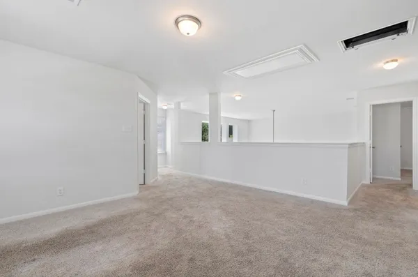 an empty room with a kitchen and a sink