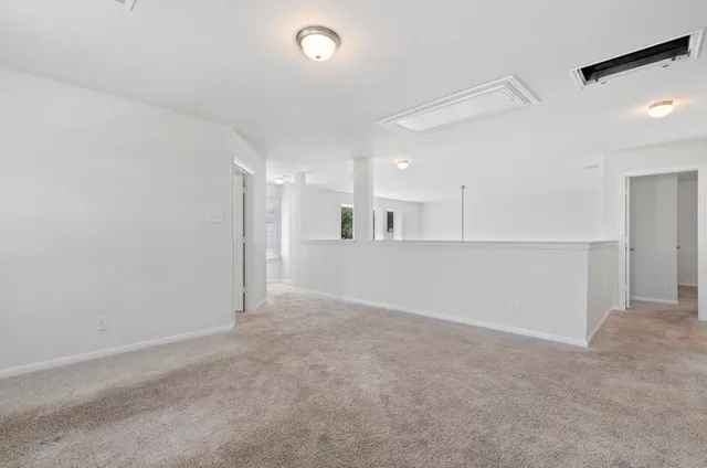 an empty room with a kitchen and a sink