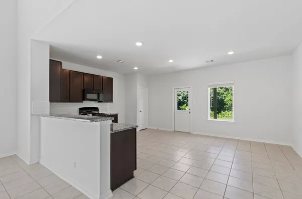 a view of room with flat screen tv and windows