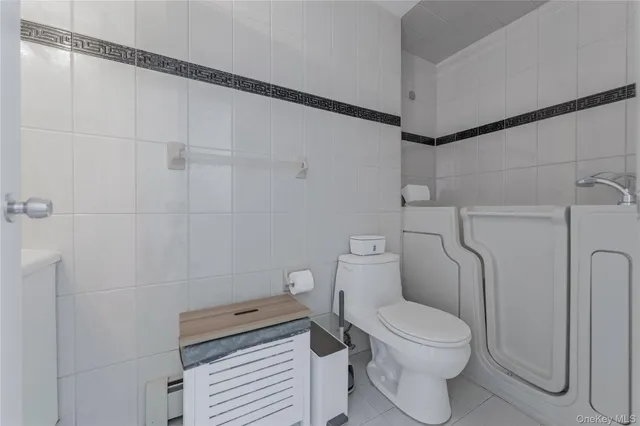 a room with water heater and a refrigerator