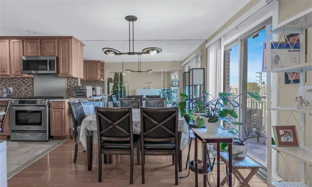 a kitchen with stainless steel appliances granite countertop a stove top oven microwave and refrigerator