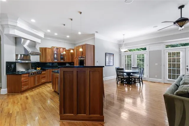 a kitchen with stainless steel appliances granite countertop a stove a sink and a microwave