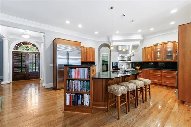 a kitchen with stainless steel appliances granite countertop a stove and a refrigerator