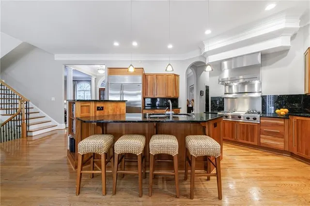 a kitchen with granite countertop a sink stove and cabinets
